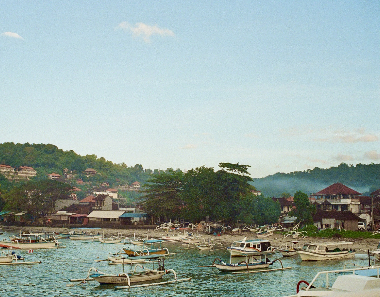 Traditional fishing boats in a Balinese harbour at dawn