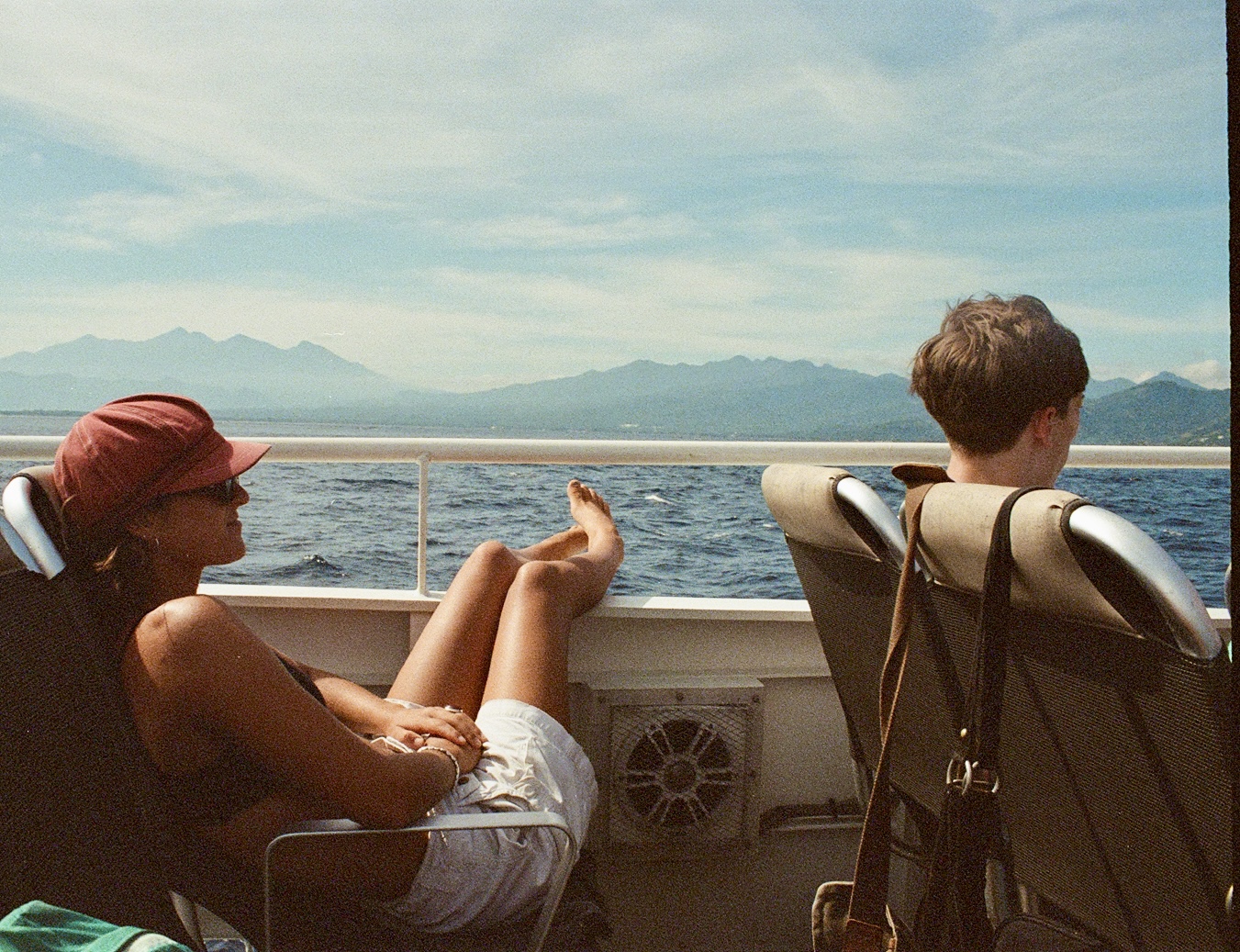 Kayden and friend on the boat to Lombok, mountains in the distance