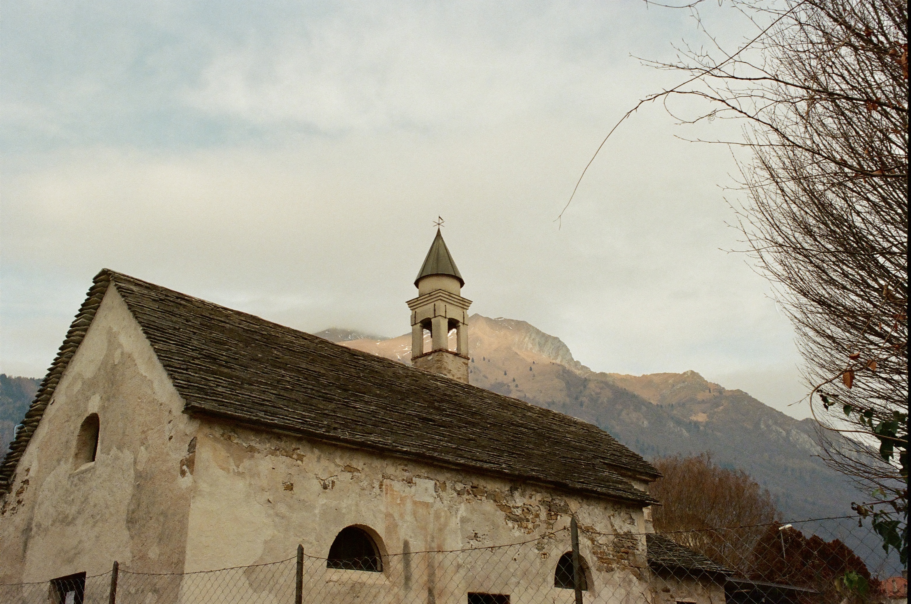 Dolomites village church with mountains behind