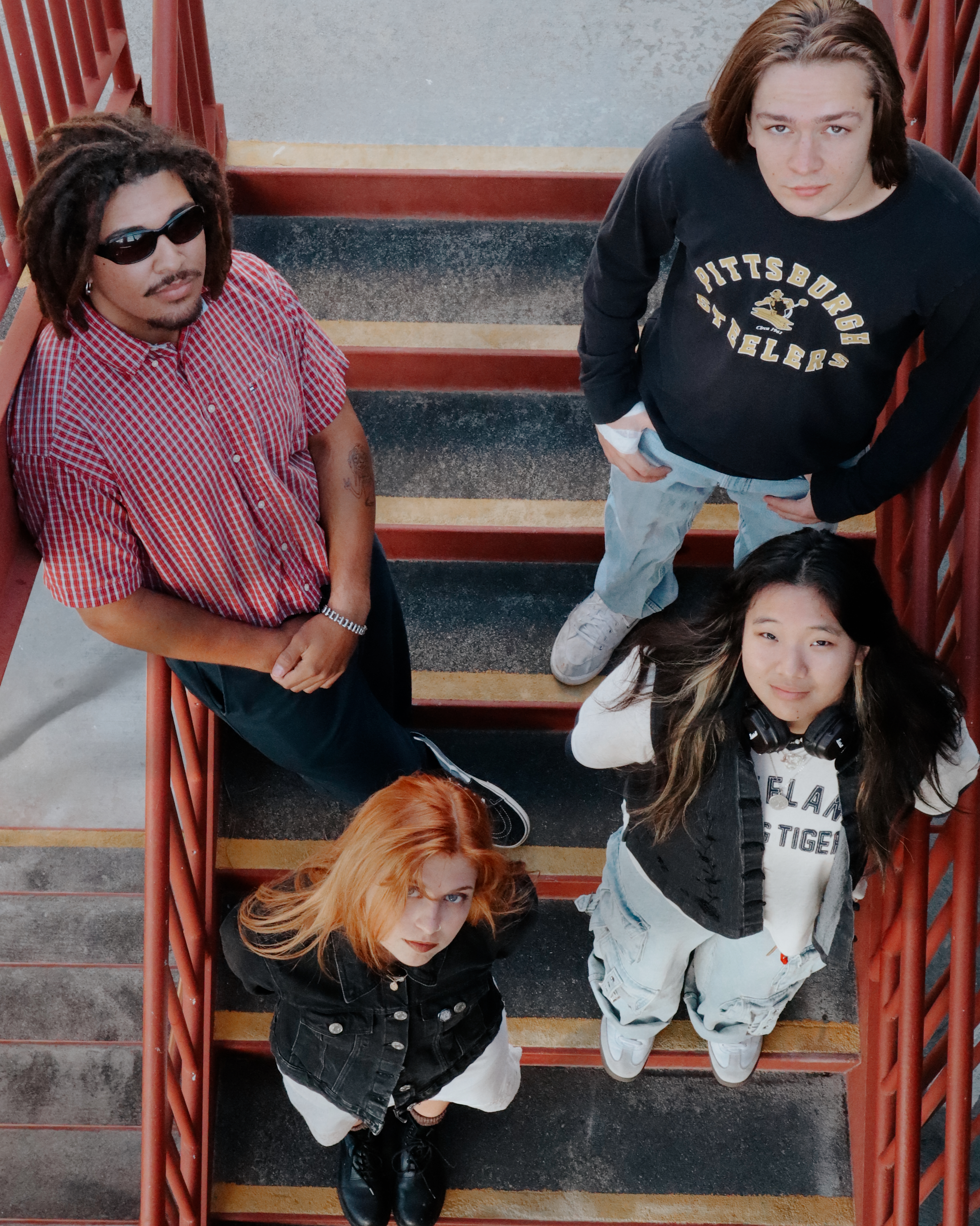 Misfire band shot from above on red stairs
