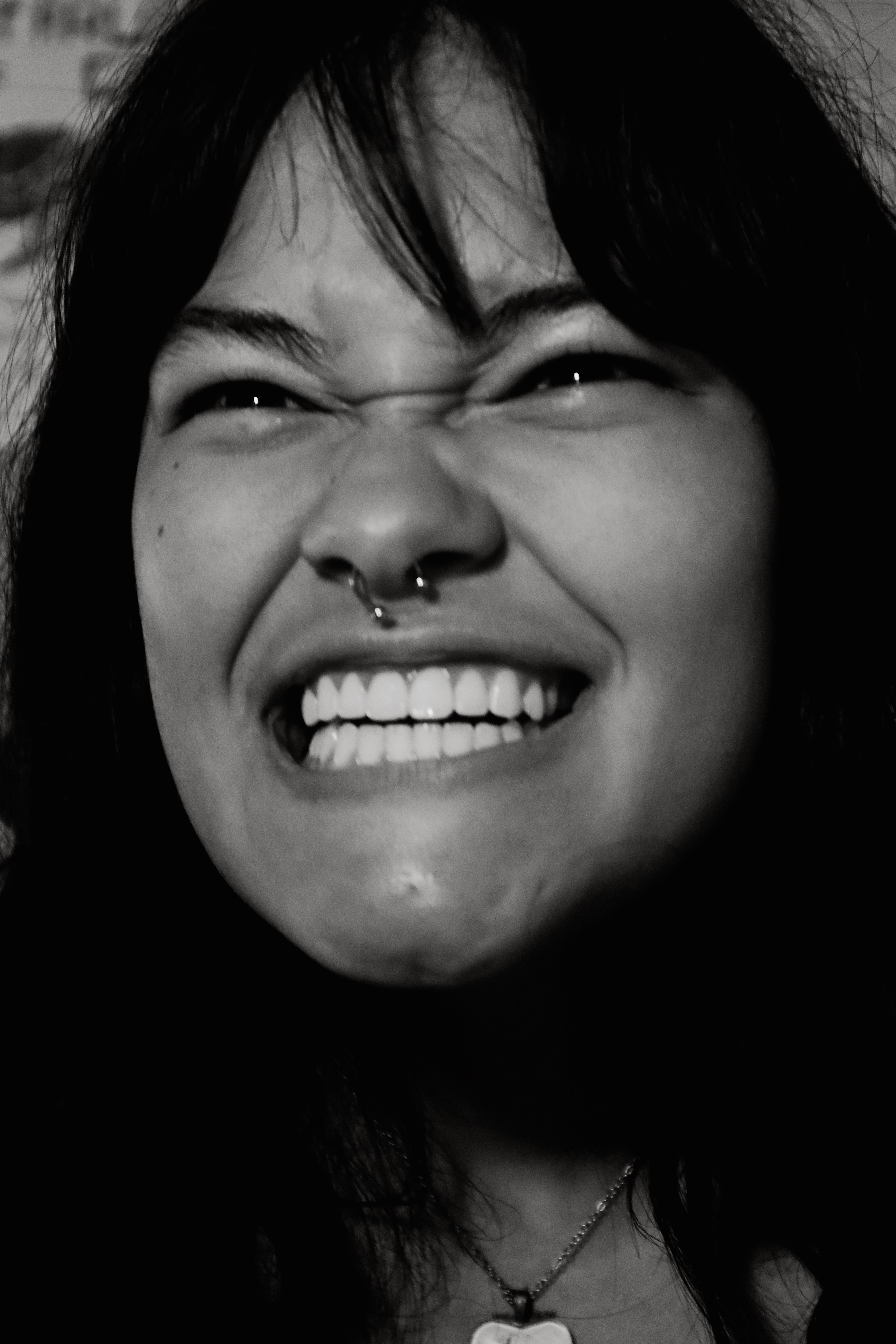 Woman laughing hard, scrunching face, black and white