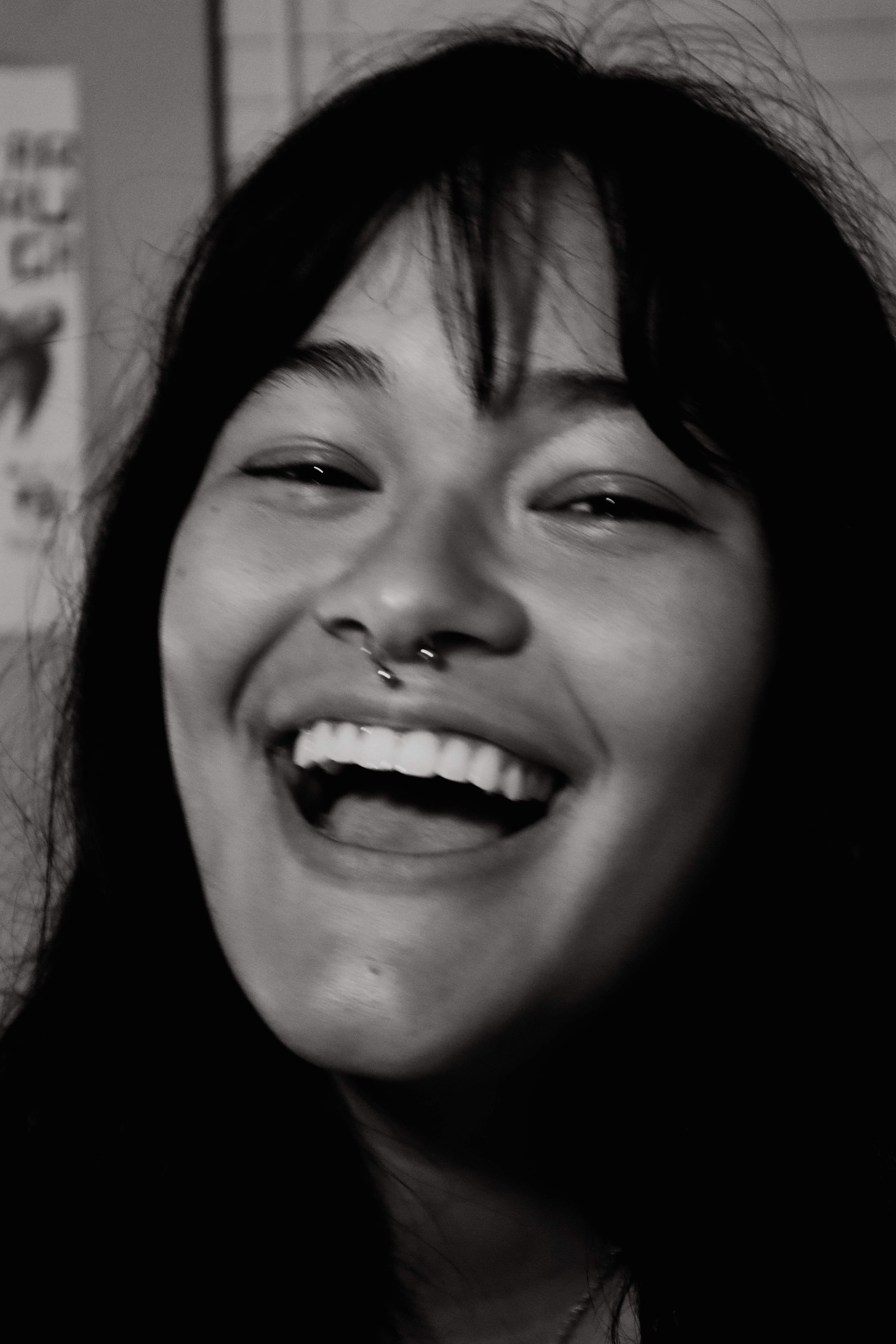 Woman laughing with eyes squinting, black and white