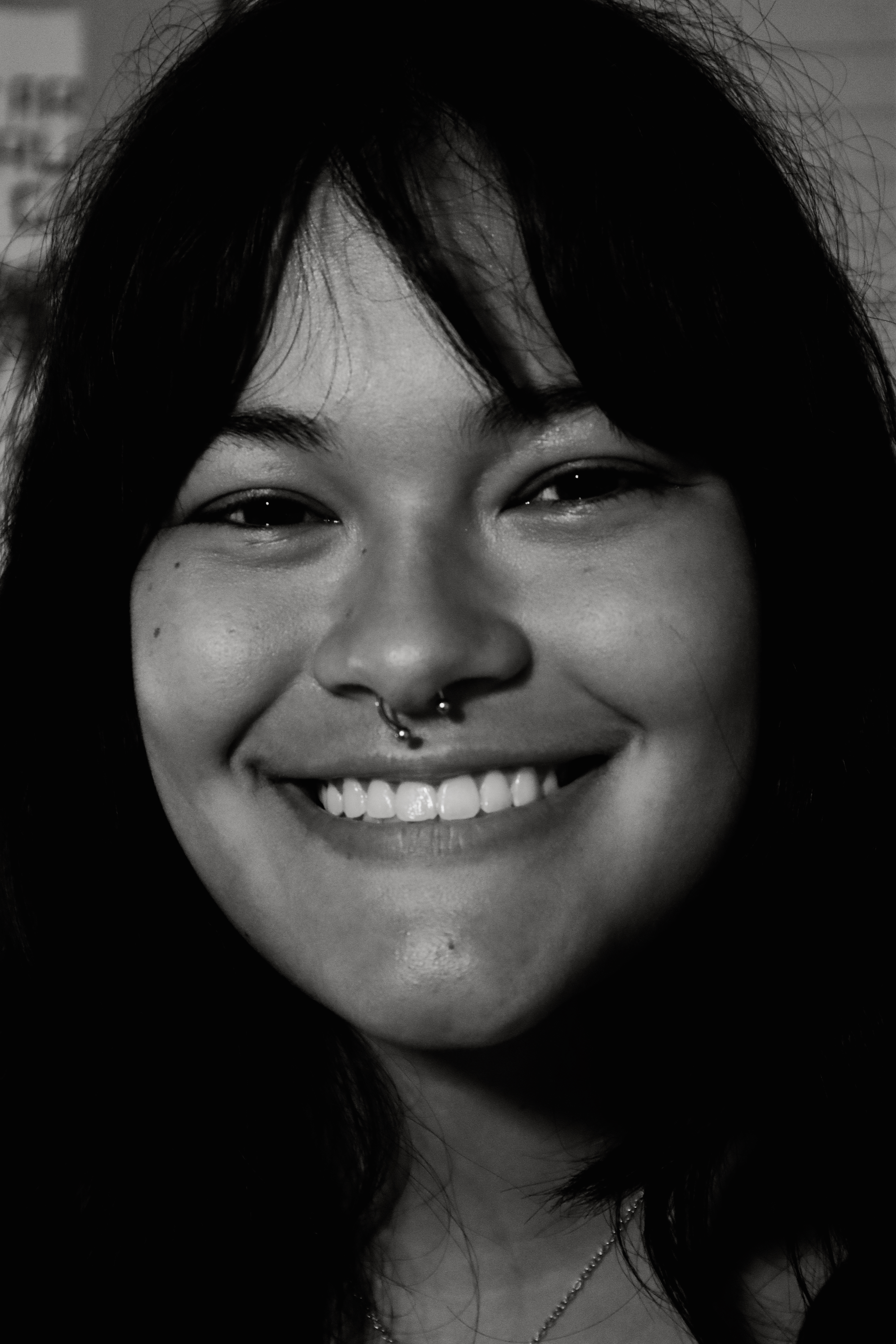 Woman smiling warmly, black and white portrait