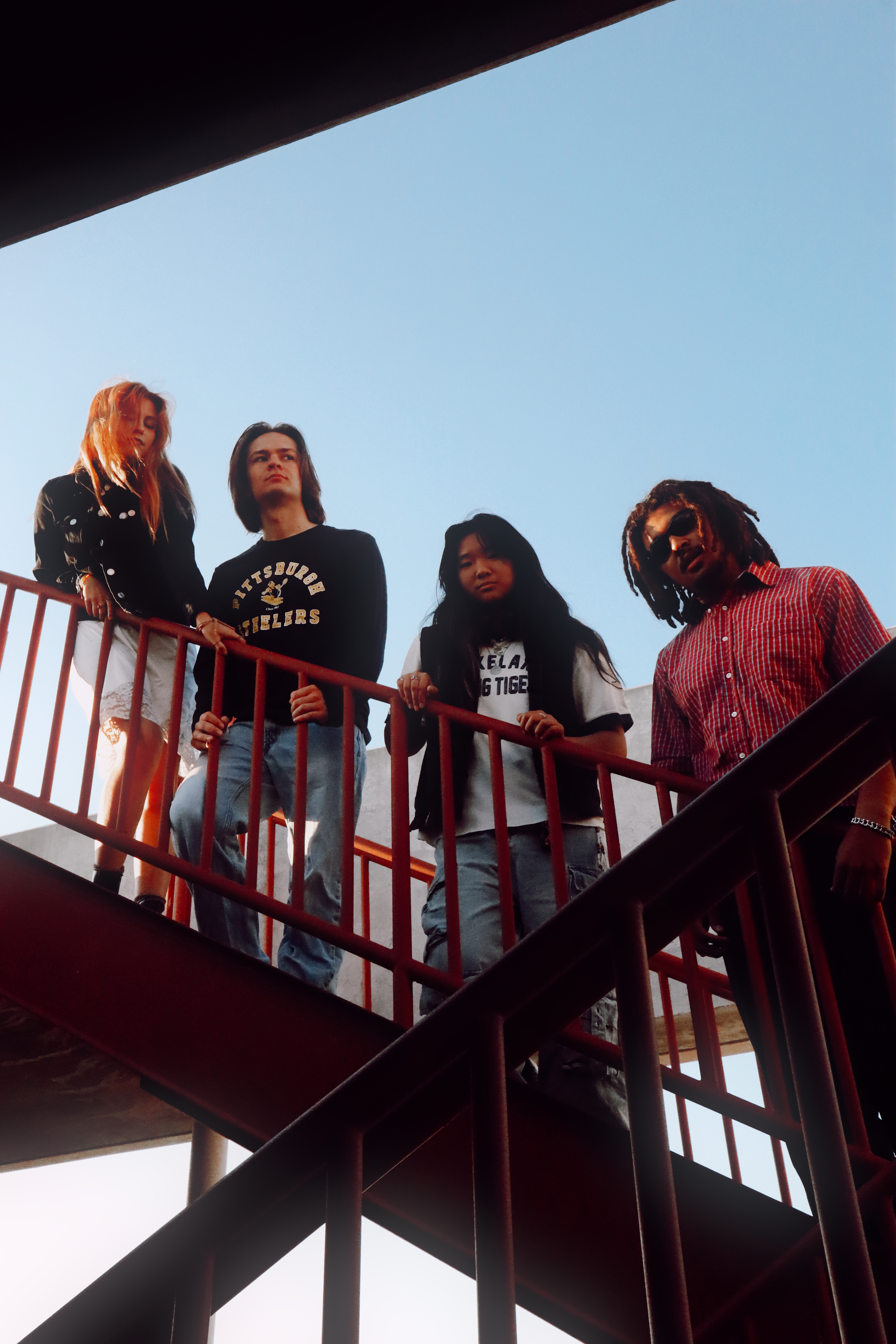 Misfire band on red fire escape stairs looking down
