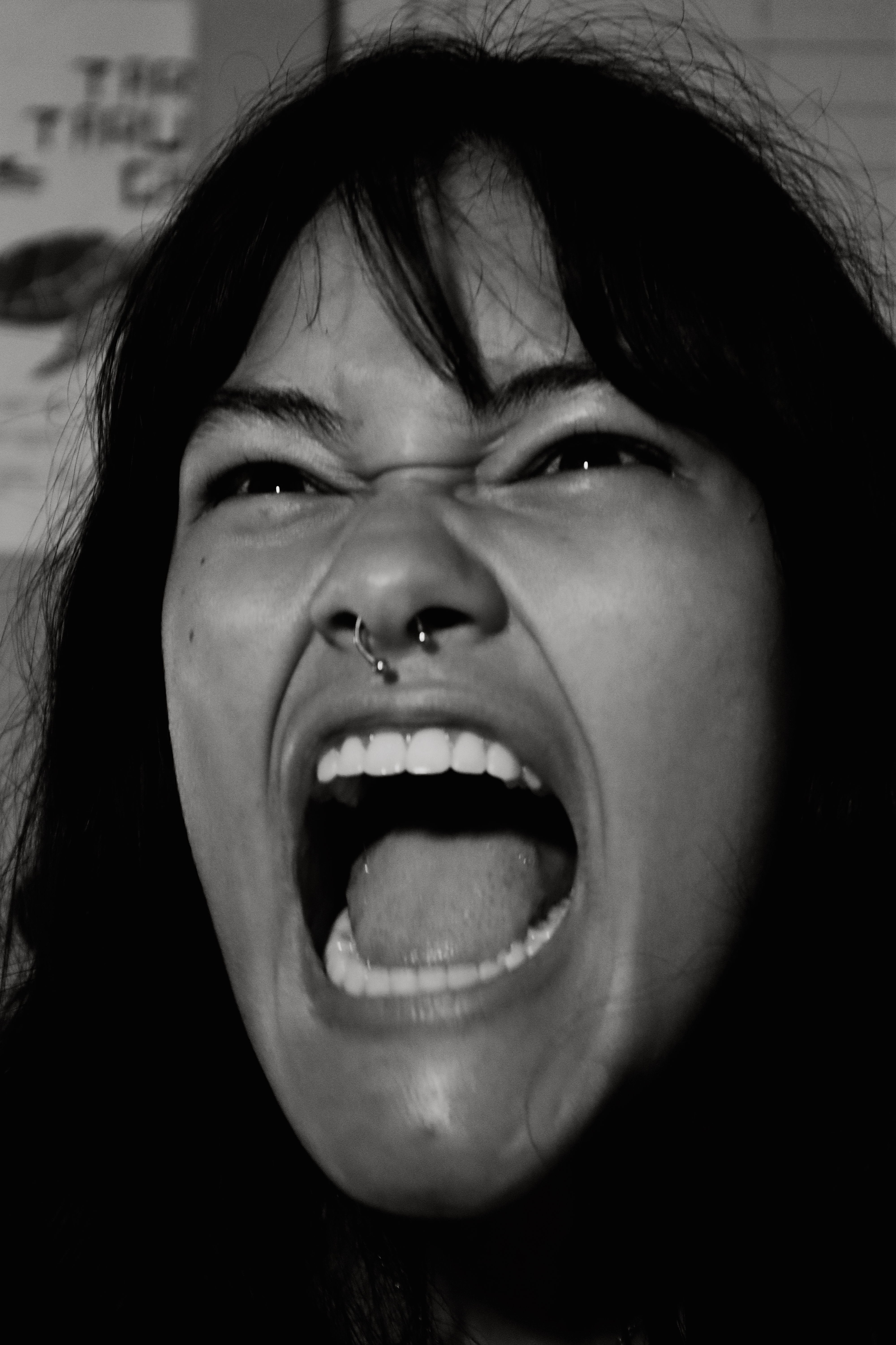 Woman screaming with mouth wide open, black and white
