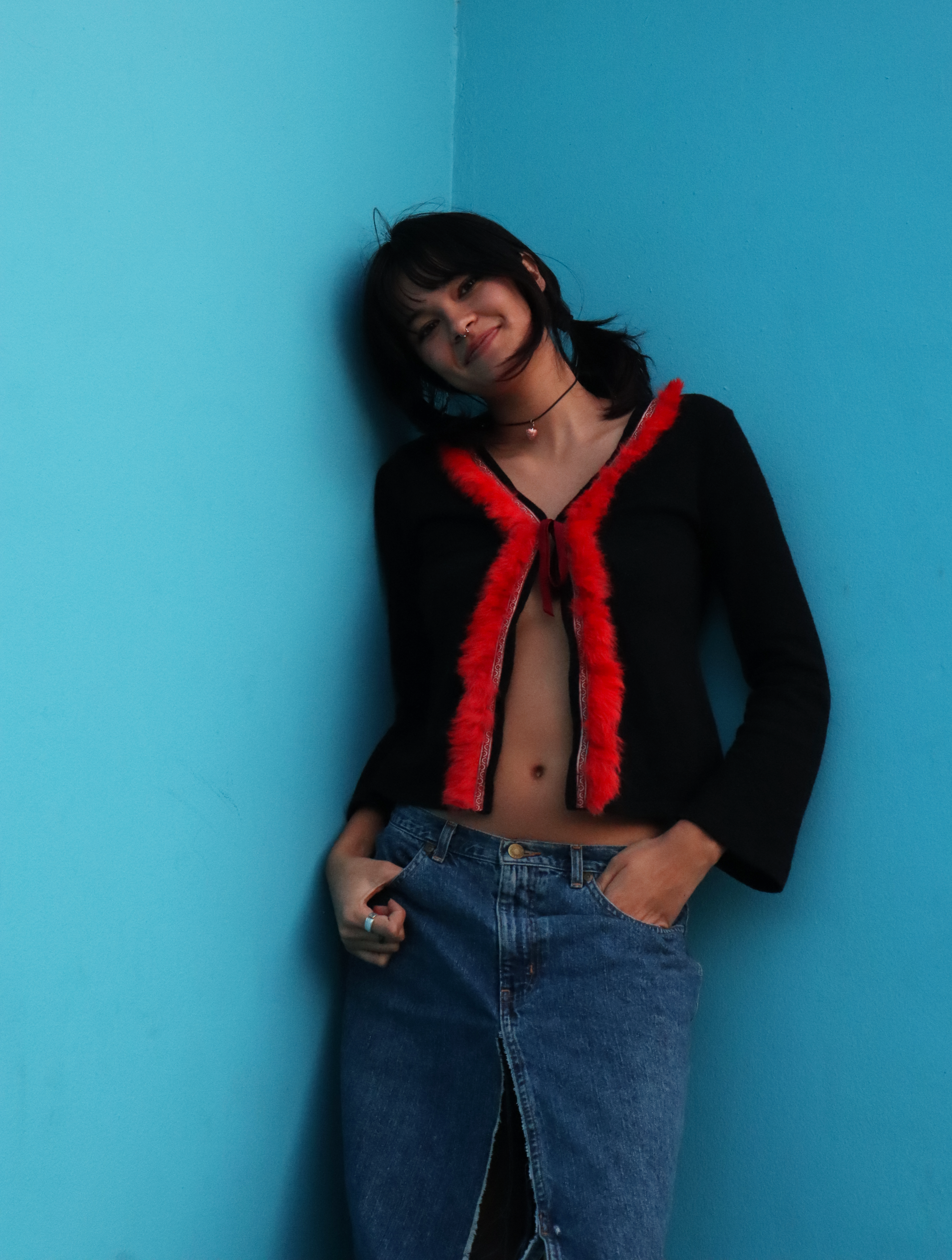 Edana leaning against a blue wall in LA