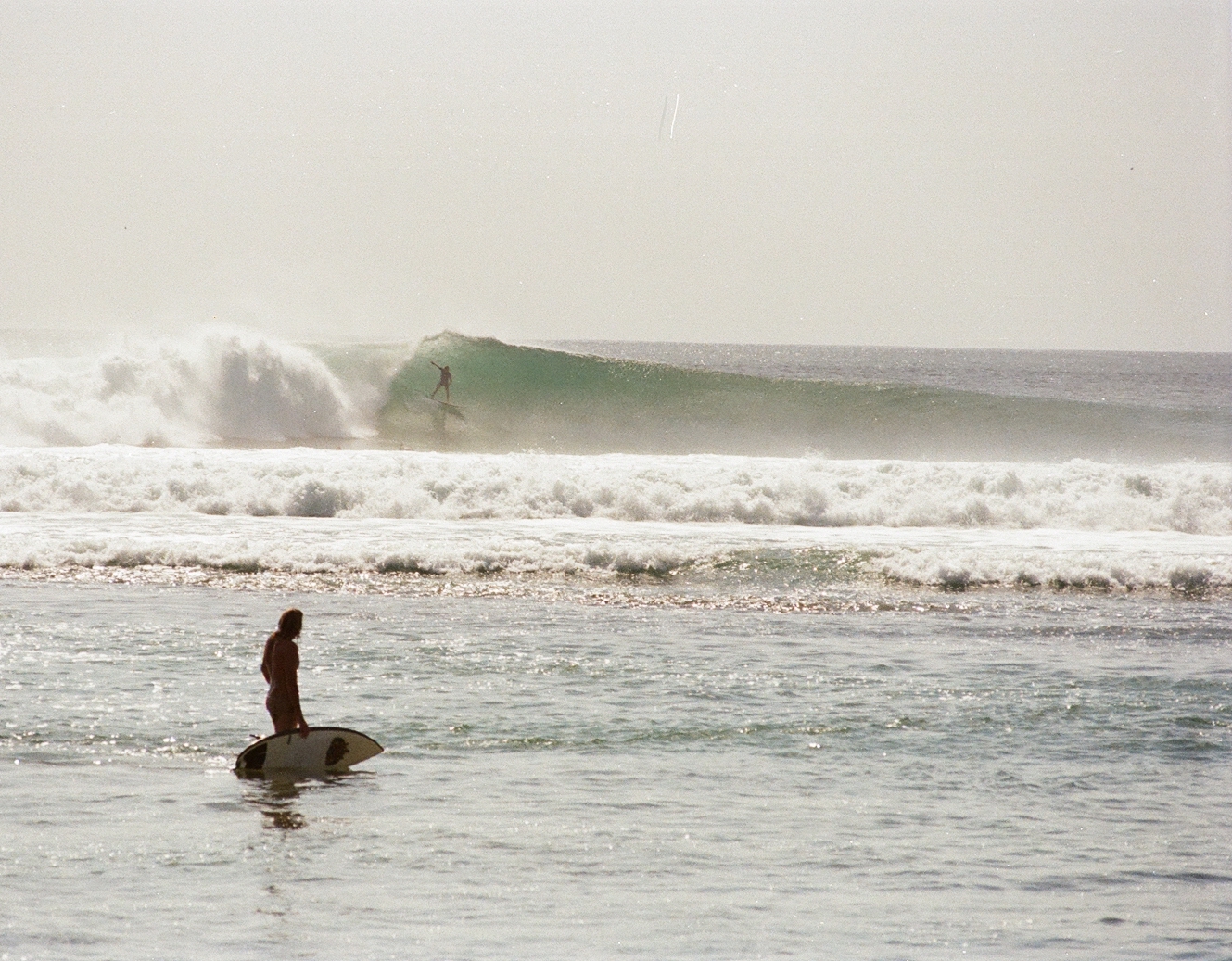 Surfer riding a perfect peeling wave